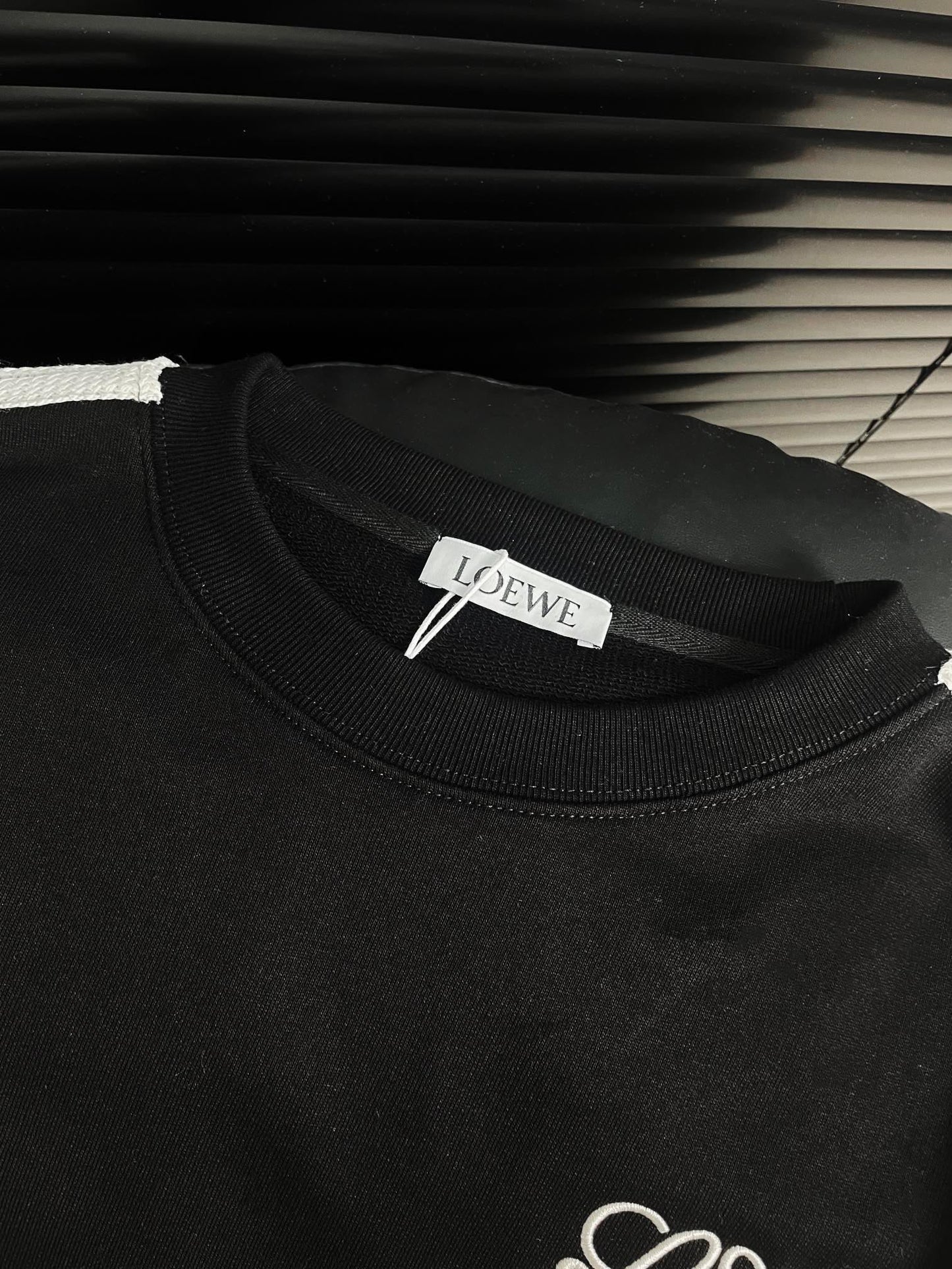 Round neck sweatshirt with embroidered small logo and hemmed ribbon