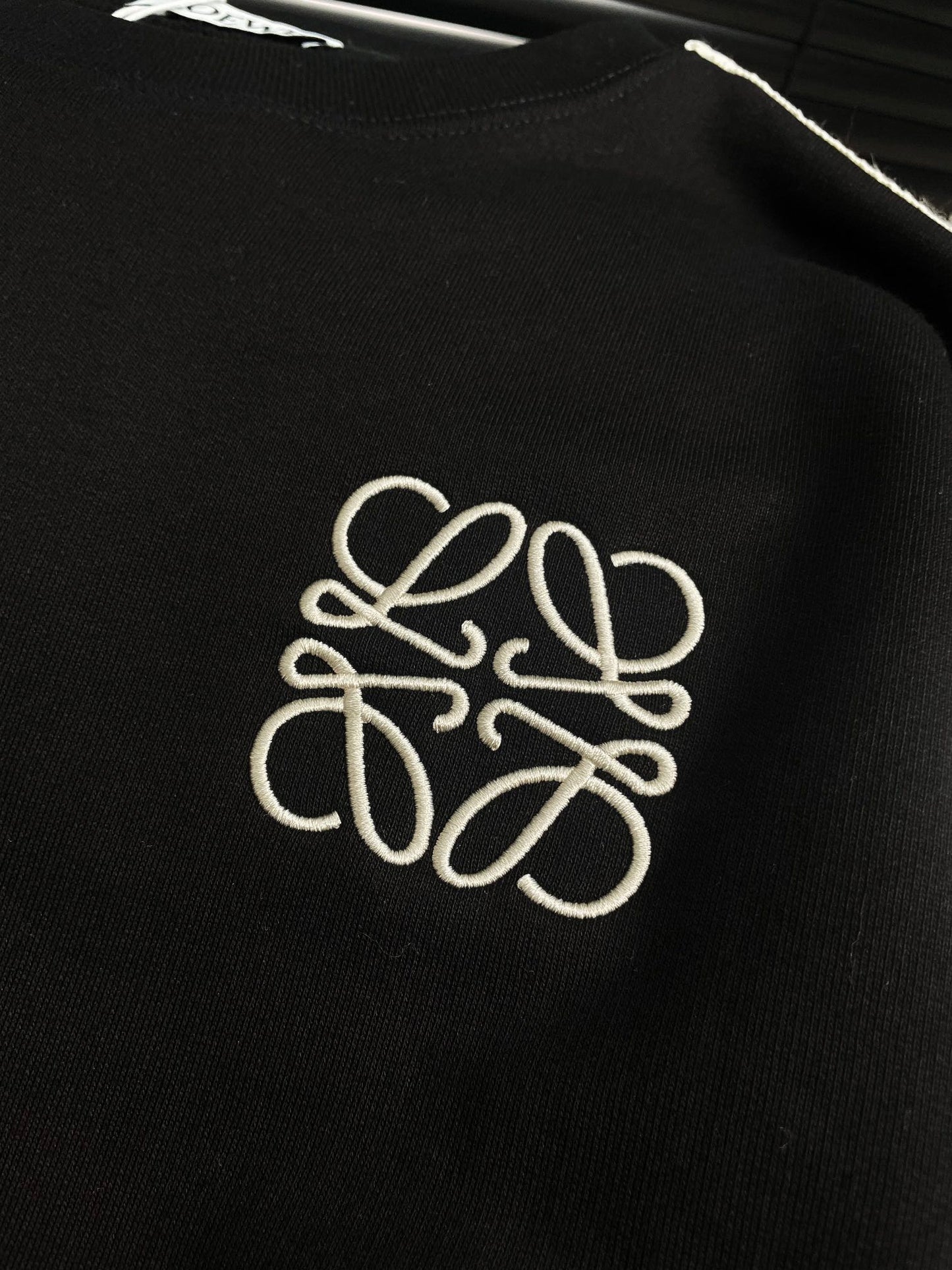 Round neck sweatshirt with embroidered small logo and hemmed ribbon