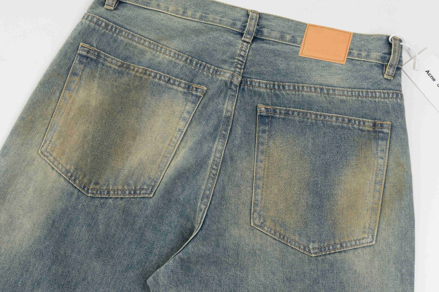 Mud-dyed distressed jeans