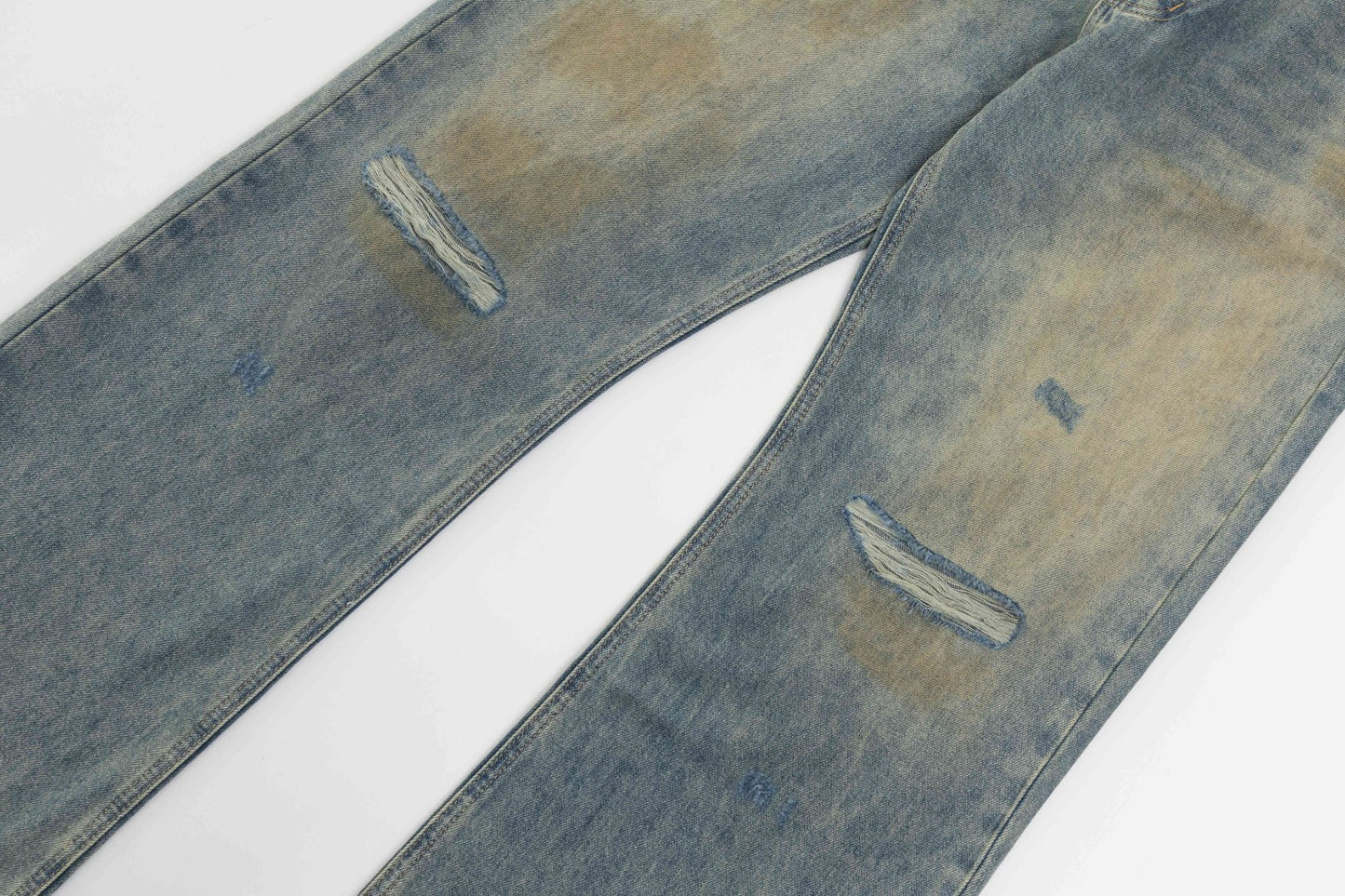 Mud-dyed distressed jeans